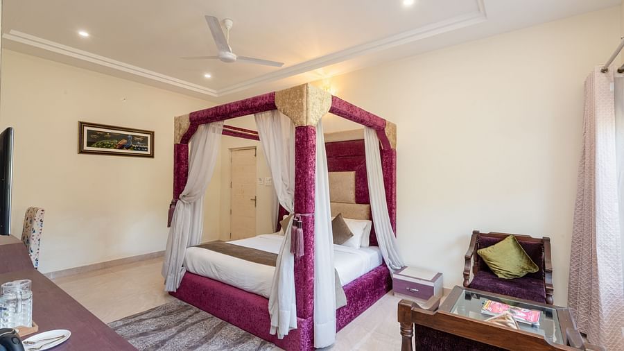 Luxurious bedroom at DLS Tehri Club Resort with a four-poster bed and elegant decor